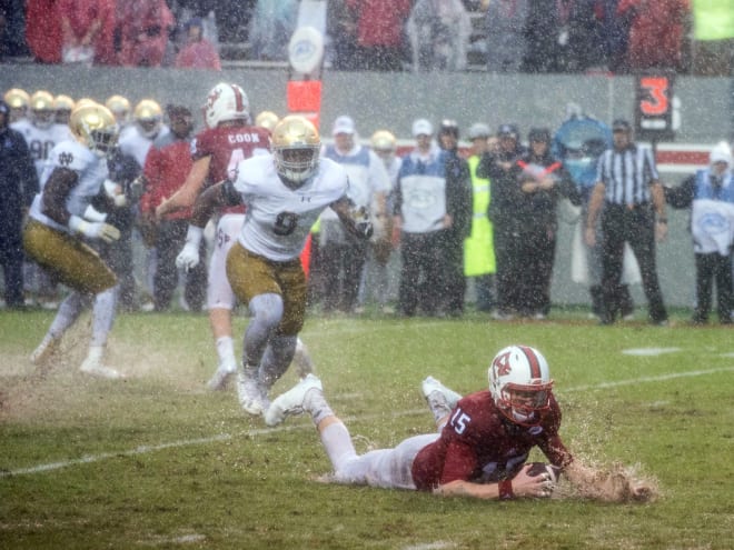 NC State quarterback Ryan Finley (15) jumps on a fumbled ball against Notre Dame in 2016 in a game that was played with heavy rains from Hurricane Matthew.