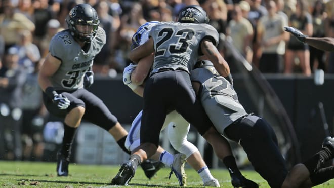 Junior safety Isaiah Lewis makes a tackle against Air Force last season 