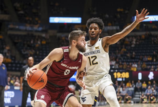 Bellarmine Knights Ethan Claycomb (0) drives with the ball against West Virginia Mountaineers guard Taz Sherman (12) during the first half at WVU Coliseum.