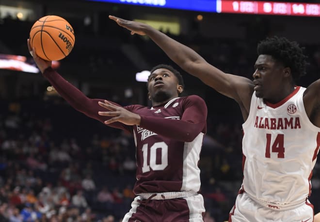 Mississippi State Bulldogs guard Dashawn Davis (10) shoots under the arms off Alabama Crimson Tide center Charles Bediako (14) during the first half at Bridgestone Arena. Photo | Steve Roberts-USA TODAY Sports