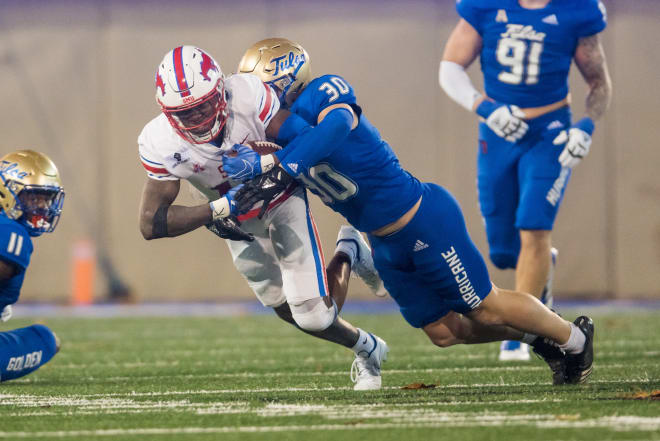SMU's Rashee Rice is tackled by Tulsa's Justin Wright (30) during Saturday's game at Chapman Stadium.