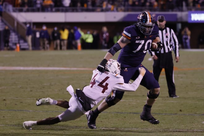 Virginia Tech defensive back Dorian Strong drags down UVa's Bobby Haskins on the ill-fated throwback to the offensive lineman.