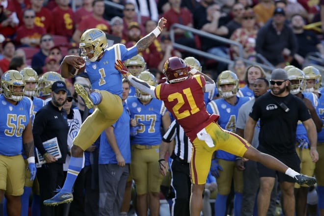USC safety Isaiah Pola-Mao pushes UCLA QB Dorian Thompson-Robinson out of bounds in the teams' game last season.