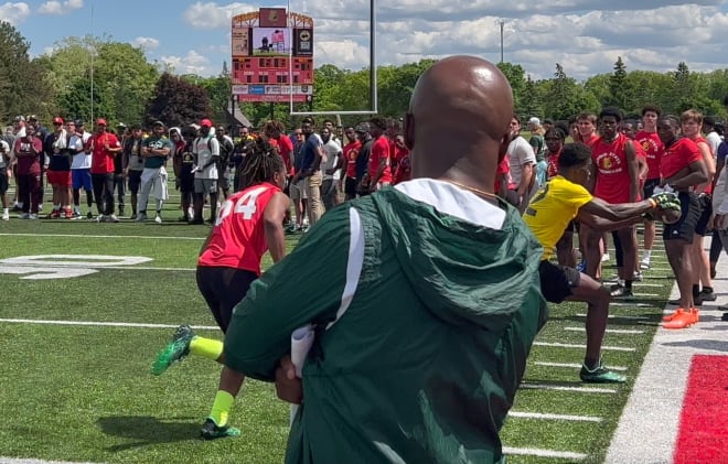 Michigan State wide receivers coach Courtney Hawkins watches 4-star WR recruit Nicholas Marsh of River Rouge snag a catch along the sidelines at the Michigan Showcase camp in Big Rapids on Thursday. | Photo by Jim Comparoni
