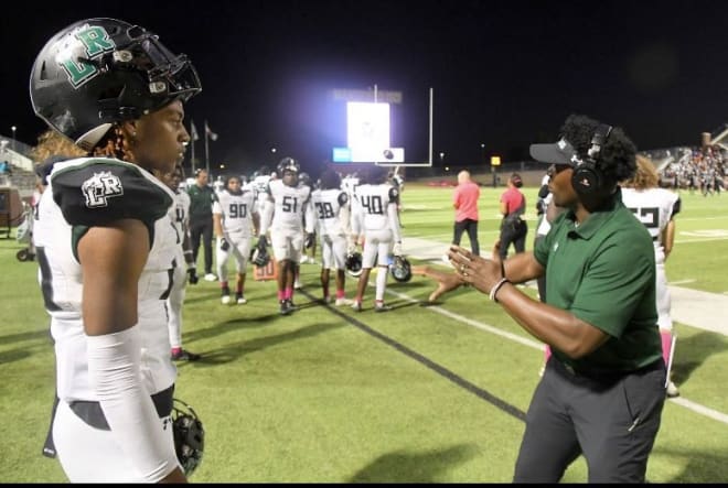 Rylan Kennedy, seen here with Mansfield Lake Ridge defensive coordinator A.J. Sheppard, has picked up several big offers in the month of November. 