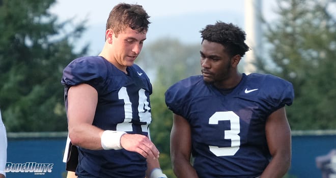 Sean Clifford and Donovan Johnson chat during preseason practice last August.