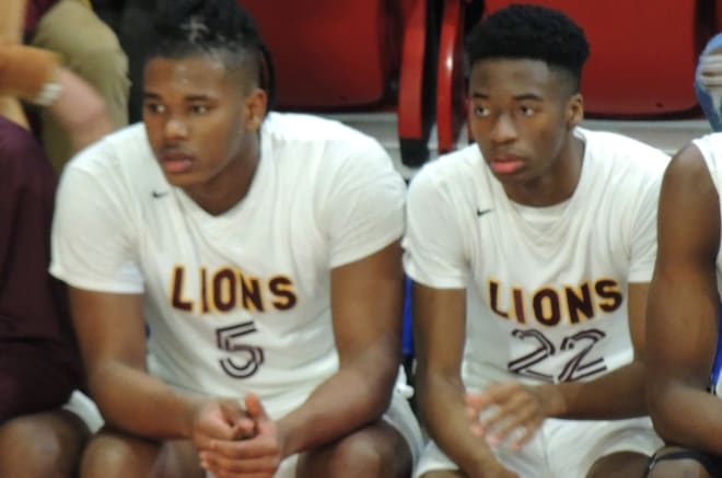 NC State junior football commit Darion Rivers of West Charlotte (N.C.) High, left, and freshman point guard Chadlyn Traylor look on Saturday at Reynolds Coliseum in Raleigh.