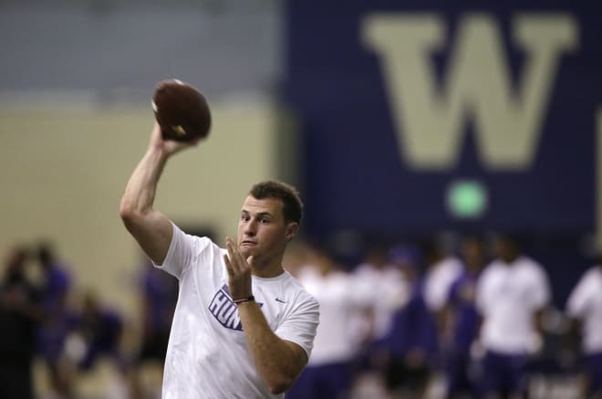 Washington quarterback K.J. Carta-Samuels throws at the team's first official NCAA college football practice of the year Monday, July 31, 2017, in Seattle. (AP Photo/Elaine Thompson)