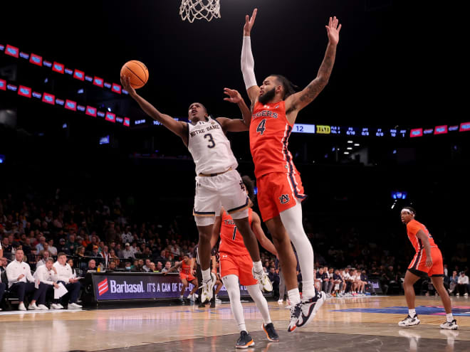 Notre Dame guard Markus Burton (3) finished 4-of-20 from the field in an 83-59 loss to Johni Broome (4) and Auburn.