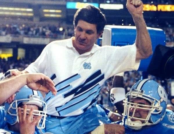 UNC players carry Mack Brown off the field after one of the program's more improtant bowl victories. 