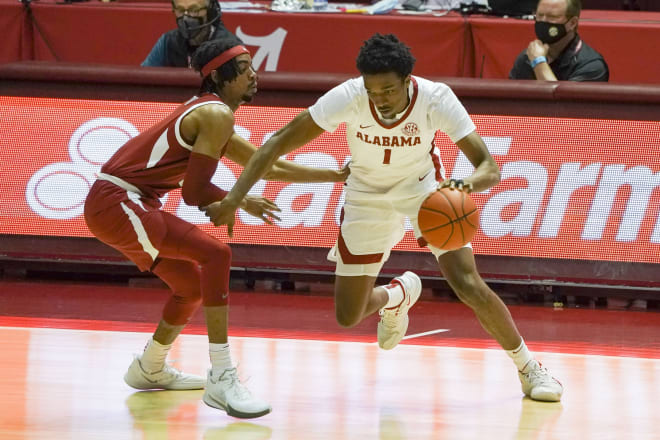 Alabama Crimson Tide forward Herbert Jones (1) controls the ball against Arkansas Razorbacks guard Jalen Tate (11) during the first half at Coleman Coliseum. Photo | Imagn