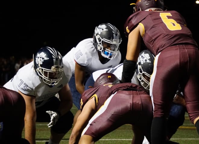 Pinnacle freshman QB Devon Dampier takes a snap from last year's Open Division playoff game at Salpointe.  Dampier was thrust into action due to the medical retirement of JD Johnson. Also pictured is senior offensive lineman Spencer Ponce (73).  (Photo by Ralph Amsden)