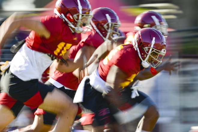 Kenan Christon, right, leads the Trojans through sprints Monday.