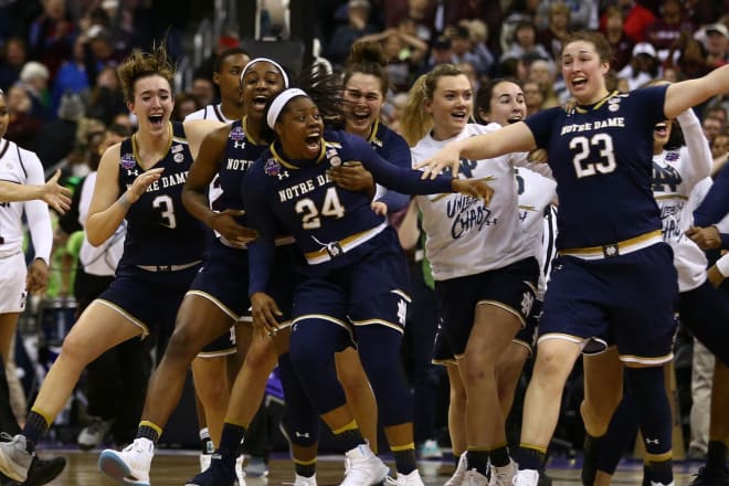 Fighting Irish players celebrate Arike Ogunbowale's (24) Instant Legend three-pointer with 0.1 seconds left to win the national title.