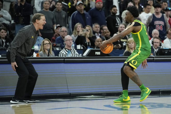 Dana Altman celebrates with Jermaine Couisnard after Friday's win over Arizona.