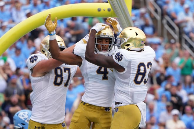 Notre Dame wide receiver Lorenzo Styles (4) celebrates his first TD reception of the season with Michael Mayer (87) and Jayden Thomas (83). 