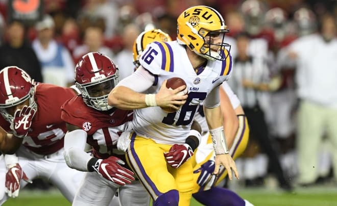 LSU Tigers quarterback Danny Etling (16) gets sacked by Alabama Crimson Tide defensive back Ronnie Harrison (15) for a loss during the second quarter at Bryant-Denny Stadium. Photo | USA Today