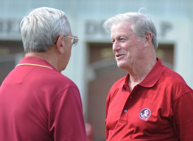 FSU President John Thrasher (right) chats with longtime "Voice of Seminole Football" Gene Deckerhoff at an FSU football practice.