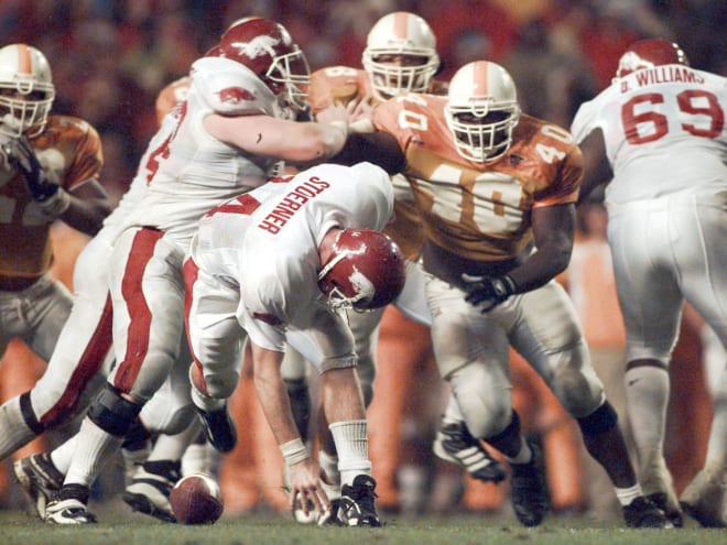 Arkansas' Clint Stoerner fumbles the ball in the closing minutes of play against Tennessee on Nov. 14, 1998, turning the ball over in Knoxville. The Vols' Billy Ratliff (40) recovered and Tennessee won the game 28-24. The play preserved Tennessee's undefeated season and they went on to win the national championship. 