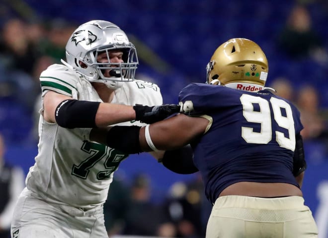 Zionsville's Joey Tanona (79) defends against Cathedral's Kendrick Gilbert (99) during the second half of a state final game Friday, Nov. 26, 2021, at Lucas Oil Stadium. The Cathedral Fighting Irish defeated the Zionsville Eagles 34-14.