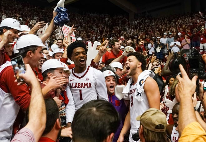 Alabama Crimson Tide forward Herbert Jones (1) and forward Alex Reese (3) celebrate with the fans after their team defeated the Auburn Tigers at Coleman Coliseum.