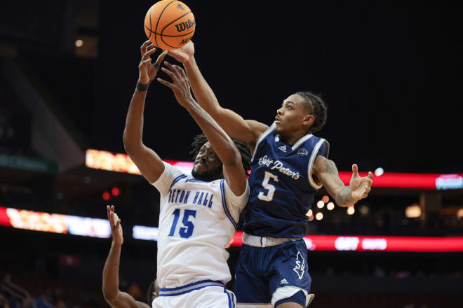 Nov 6, 2023; Newark, New Jersey, USA; Seton Hall Pirates center Jaden Bediako (15) battles for a rebound against St. Peter's Peacocks guard Armoni Zeigler (5) during the first half at Prudential Center.