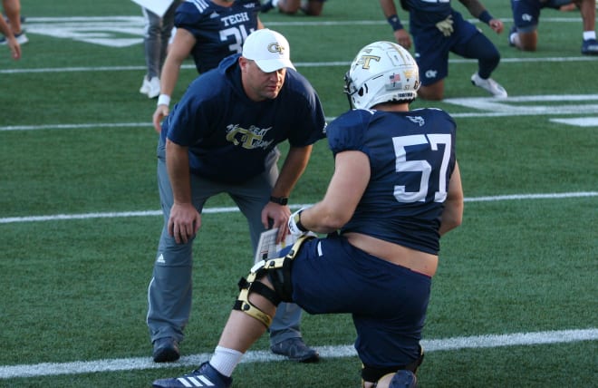 OL coach Brent Key talks with Mikey Minihan last week during flex 