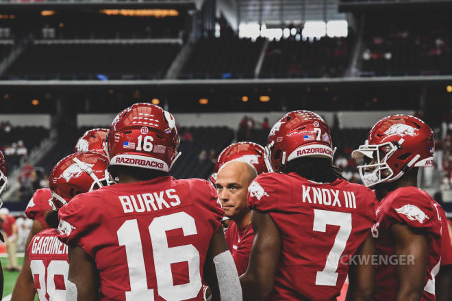 Arkansas wide receivers coach Justin Stepp in the huddle.