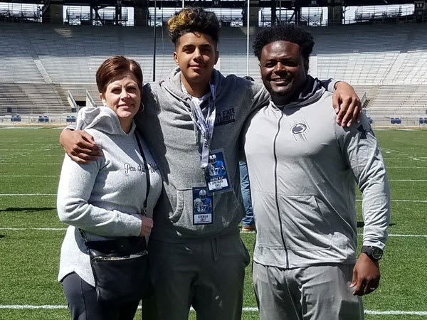 Gray and his parents pose for a photo inside Beaver Stadium.