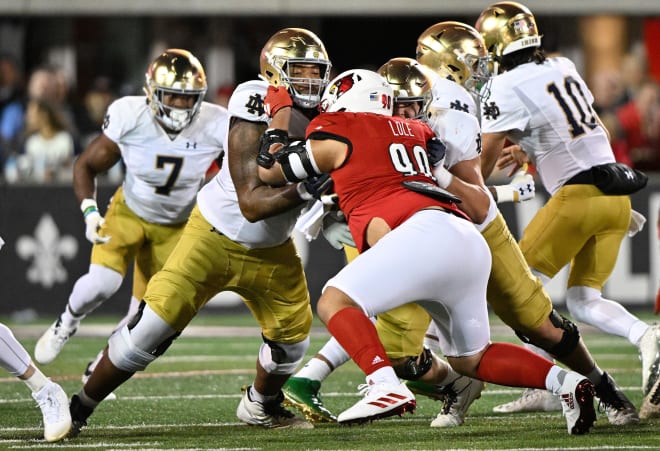 Notre Dame offensive tackle Blake Fisher takes on Louisville defender Jermayne Lole during ND's 33-20 loss at Louisville on Saturday night.