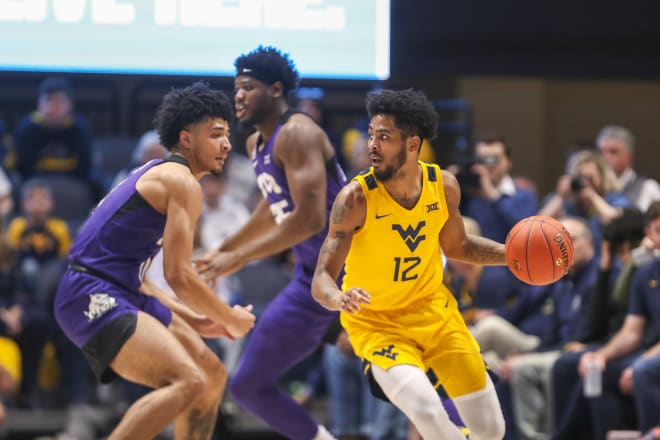 West Virginia Mountaineers guard Taz Sherman (12) dribbles during the first half against the TCU Horned Frogs at WVU Coliseum.