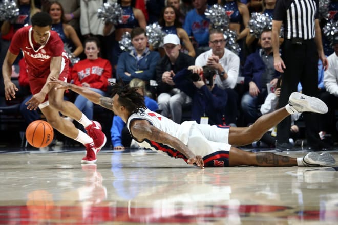 Ole Miss Rebels guard Allen Flanigan (7) dives for a loose ball as Alabama Crimson Tide guard Rylan Griffen (3) scoops it up during the first half at The Sandy and John Black Pavilion at Ole Miss. Mandatory Credit: Petre Thomas-USA TODAY Sports