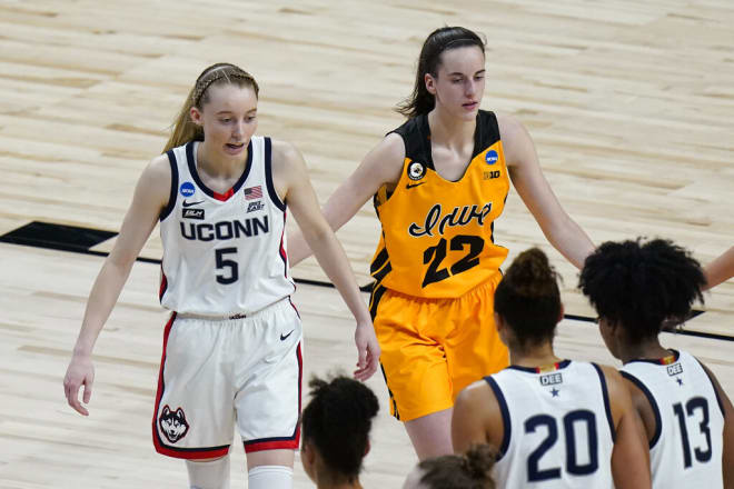 Paige Bueckers (5) and Caitlin Clark (22) face off in NCAA Tournament action in 2021.