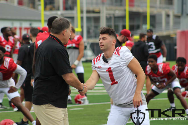 Rutgers football HC Greg Schiano shaking hands with K Valentino Ambrosio at practice