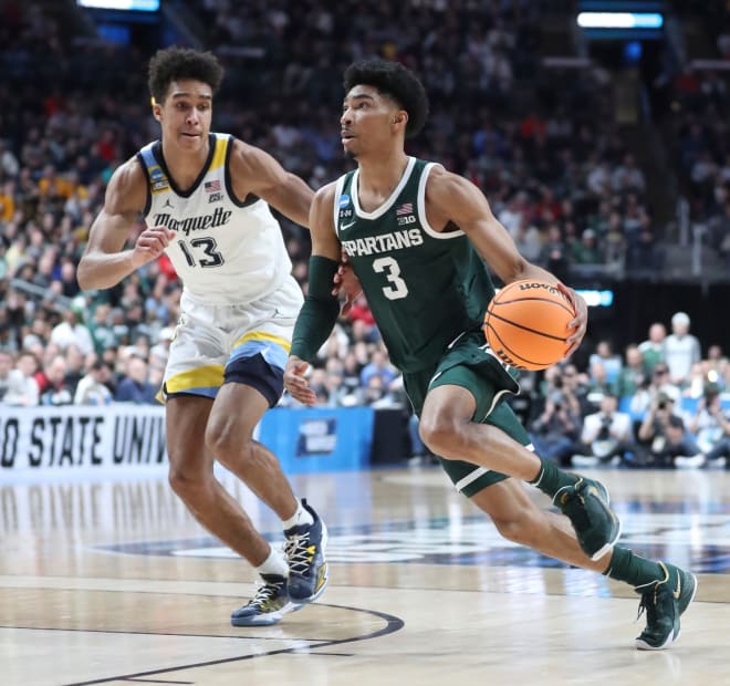 Michigan State Spartans guard Jaden Akins drives against Marquette Golden Eagles forward Oso Ighodaro during the first half in the second round of the NCAA tournament Sunday, March 19, 2023 in Columbus, Ohio.