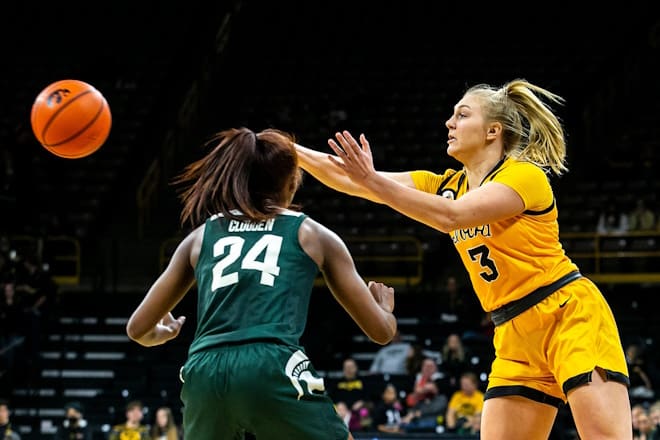 Iowa guard Sydney Affolter (3) passes the ball as Michigan State guard Nia Clouden (24) defends during a NCAA Big Ten Conference women's basketball game, Sunday, Dec. 5, 2021, at Carver-Hawkeye Arena in Iowa City, Iowa. 