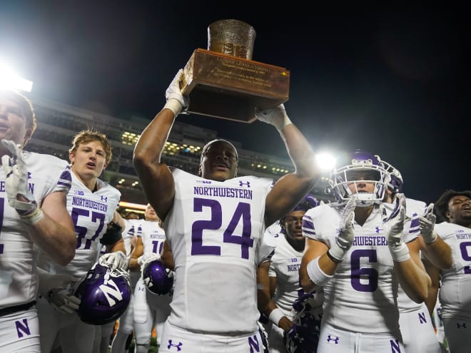 Former Northwestern defensive back Rod Heard II, pictured hoisting the Land of Lincoln Trophy, has committed to a graduate transfer to Notre Dame. 