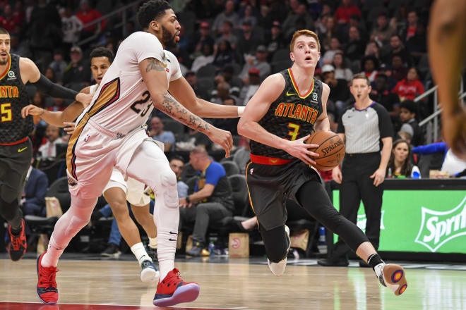 Kevin Huerter (No. 3) drives past New Orleans big man Anthony Davis during Atlanta's March 10 win over the Pelicans.