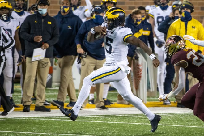 Michigan Wolverines quarterback Joe Milton runs with the football at Minnesota