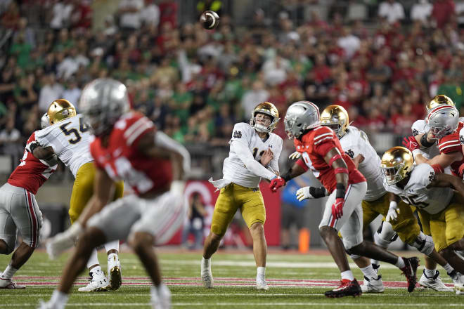 Tyler Buchner (center) completed 10-of-18 passes against Ohio State.
