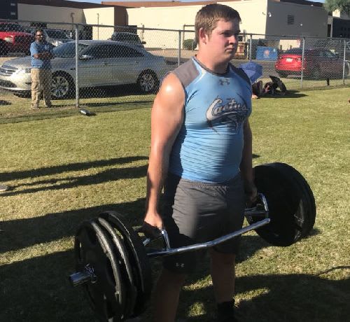 Colton Lawrence of Cactus totes the weight during the Farmer's Carry at the West Valley Big Man Challenge in Goodyear.  The exercise can improve grip strength, gain muscle, get the heart rate going, and help get stronger.