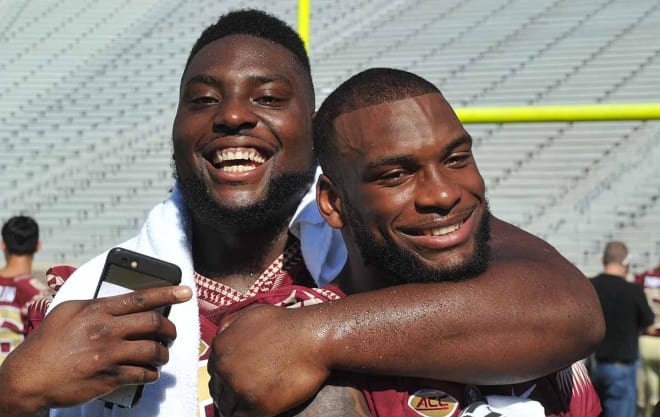 Defensive tackle Derrick Nnadi, left, was one of several current Seminole players who participated in Saturday's youth camp on the FSU campus.