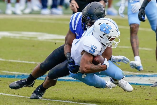 Tony Davis makes a tackle against UNC's Dazz Newsome during a 2020 game. 