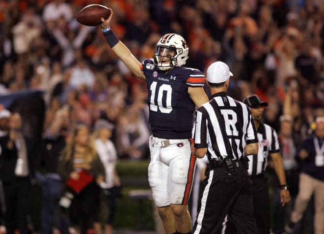 Nix (10) celebrates with the game ball after the final play of the 2019 Iron Bowl.