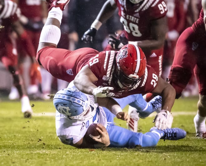 NC State Wolfpack football defensive tackle Alim McNeill makes a tackle.