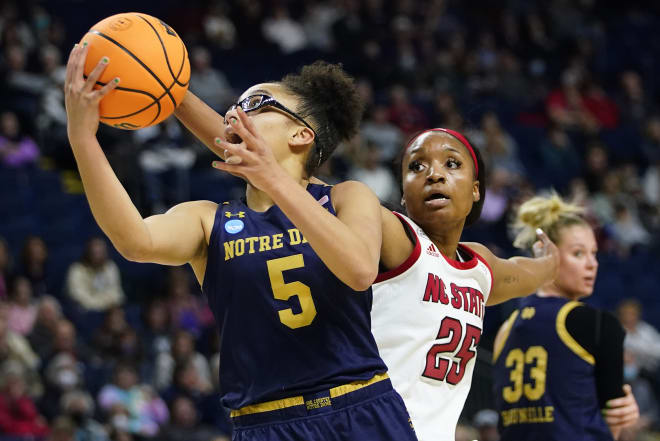 Notre Dame freshman Olivia MIles (5) scores two of her 21 points as NC State's Kayla Jones (25) defends during an NCAA Sweet 16 matchup, Saturday in Bridgeport, Conn.