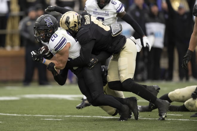 Nov 19, 2022; West Lafayette, Indiana, USA; Northwestern Wildcats running back Evan Hull (26) is tackled by Purdue Boilermakers linebacker Jalen Graham (6) during the second half at Ross-Ade Stadium. Mandatory Credit: Marc Lebryk-USA TODAY Sports