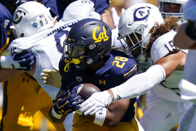 UC Davis linebacker Teddye Buchanan (15) makes a tackle in a game against Cal early in the 2022 season. Buchanan committed to the Bears Tuesday.