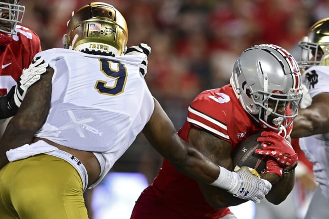 Ohio State running back Miyan Williams runs the ball as Notre Dame defensive lineman Justin Ademilola reaches for him during OSU's 21-10 win, Saturday night in Columbus, Ohio.