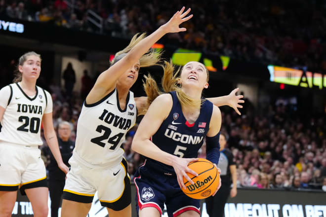 Apr 5, 2024; Cleveland, OH, USA; Connecticut Huskies guard Paige Bueckers (5) controls the ball against Iowa Hawkeyes guard Gabbie Marshall (24) in the third quarter in the semifinals of the Final Four of the womens 2024 NCAA Tournament at Rocket Mortgage FieldHouse. 